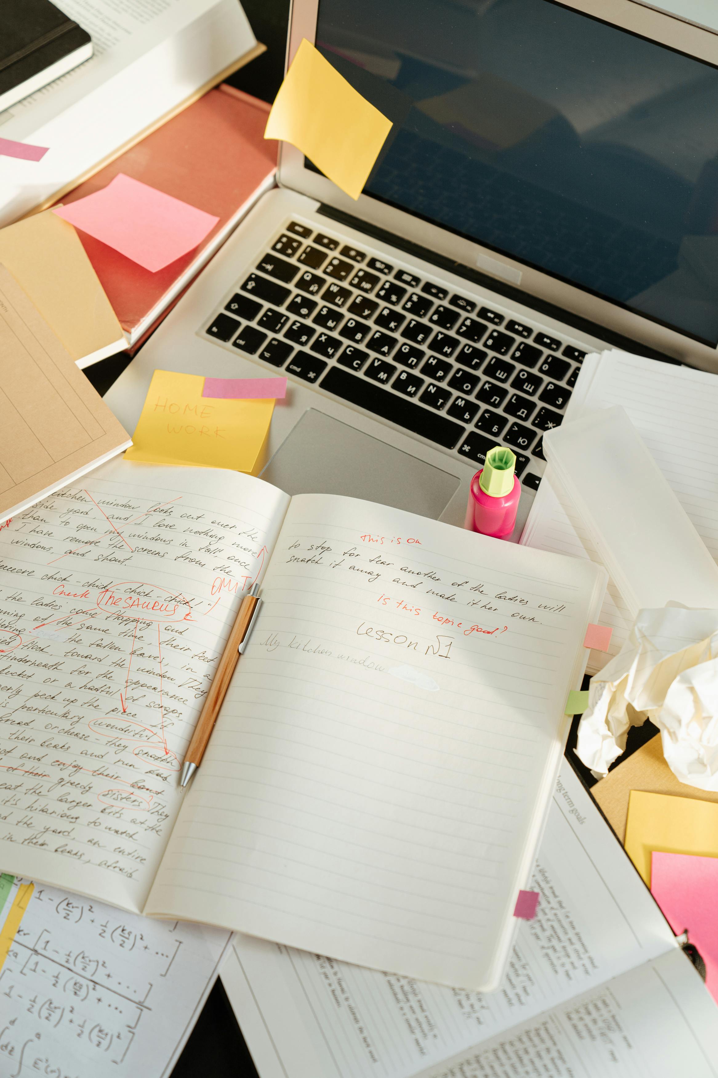 Person working on laptop with phone nearby